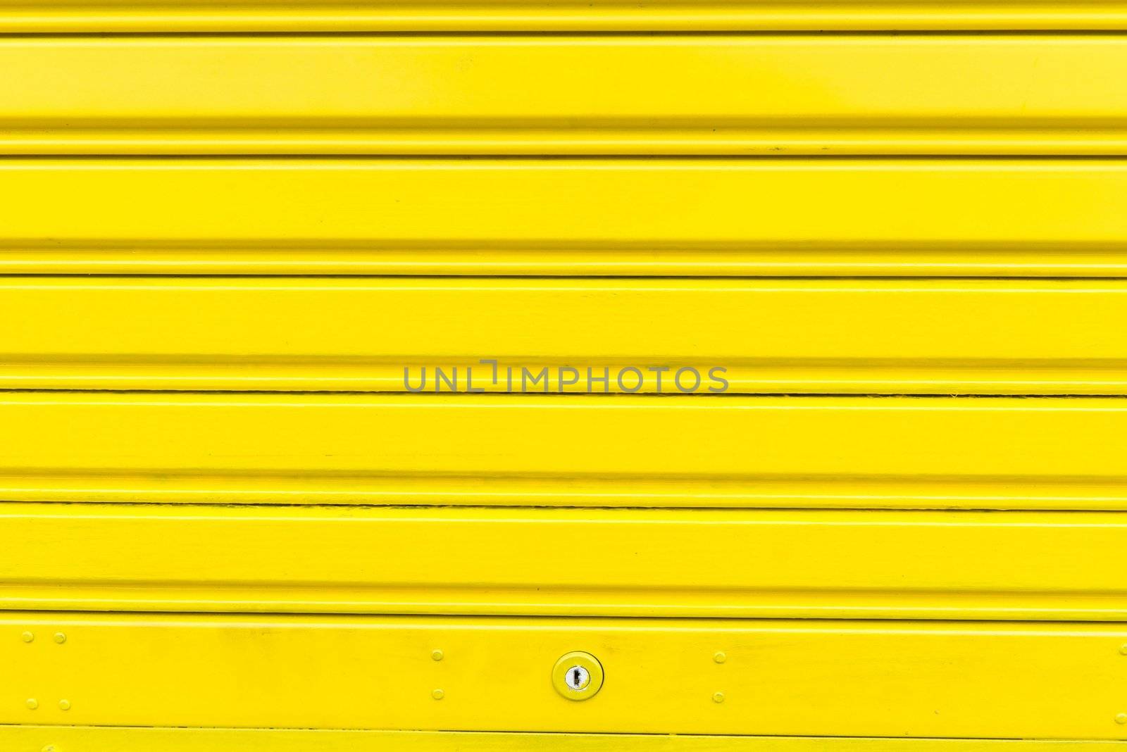 Bright yellow metal sliding door with key hole by sasilsolutions