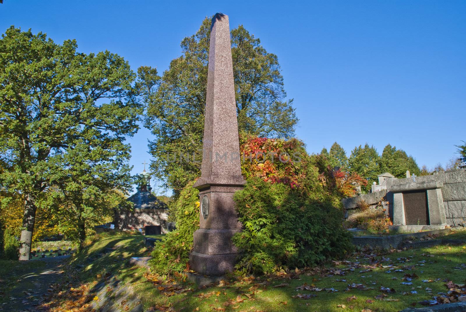 on the os cemetery in halden, there are several old grave monuments, image is shot inside the cemetery. picture shows os cemetery located in the center of halden