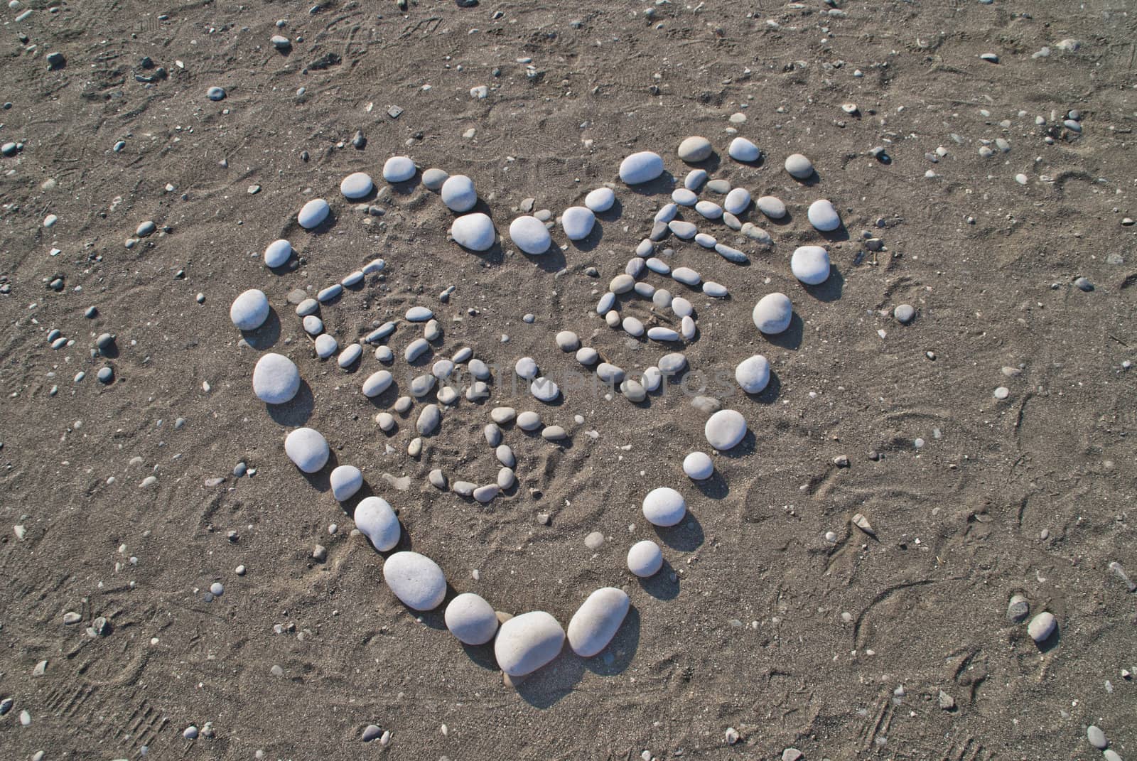 written with stones and shaped like a heart on the beach to the Hotel Sun Beach Resort in Ixia, Rhodes. Image is shot on vacation in Rhodes autumn 2012.