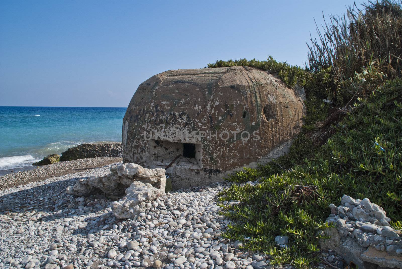 bunkers molded and constructed in concrete from the World War II located on the beach at Hotel Sun Beach Resort in Ixia, Rhodes. Image is shot on vacation in Rhodes autumn 2012.