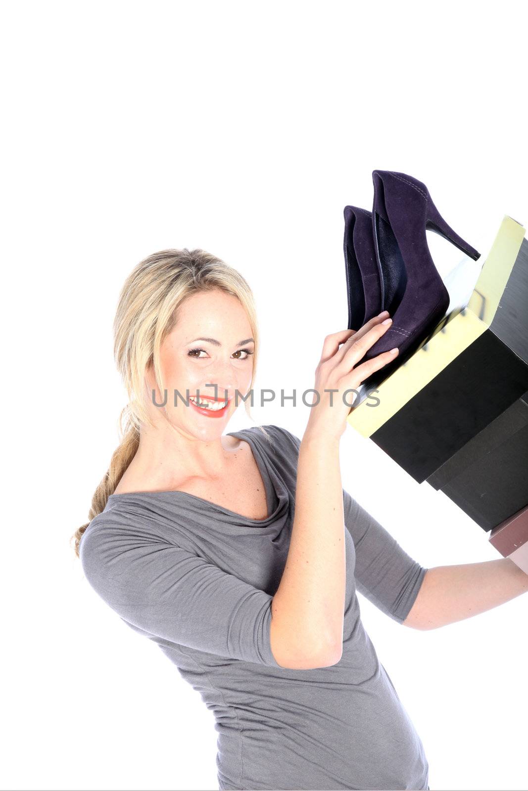 Smiling blonde woman holding high heels and shoe boxes on white background