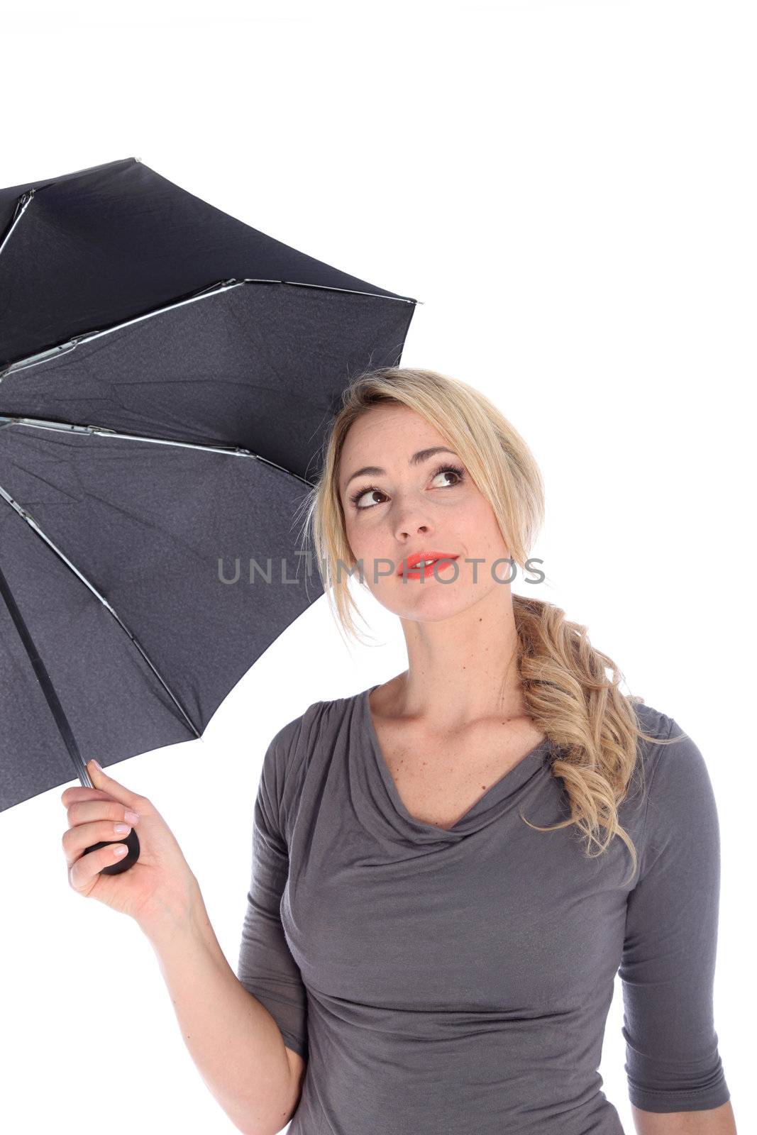 Beautiful blonde woman holding umbrella and looking towards the sky on white background