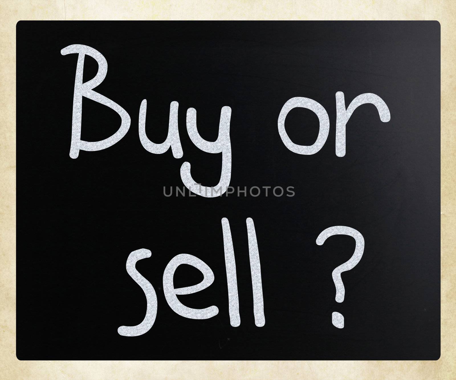 "Buy or sell" handwritten with white chalk on a blackboard.