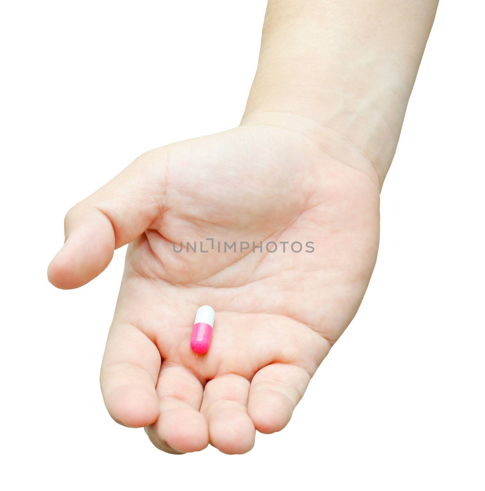 Hand with pill isolated on white background.
