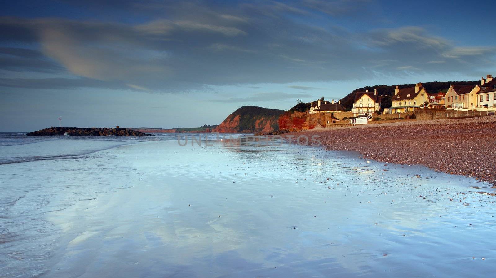 Sidmouth beach at sunset by olliemt