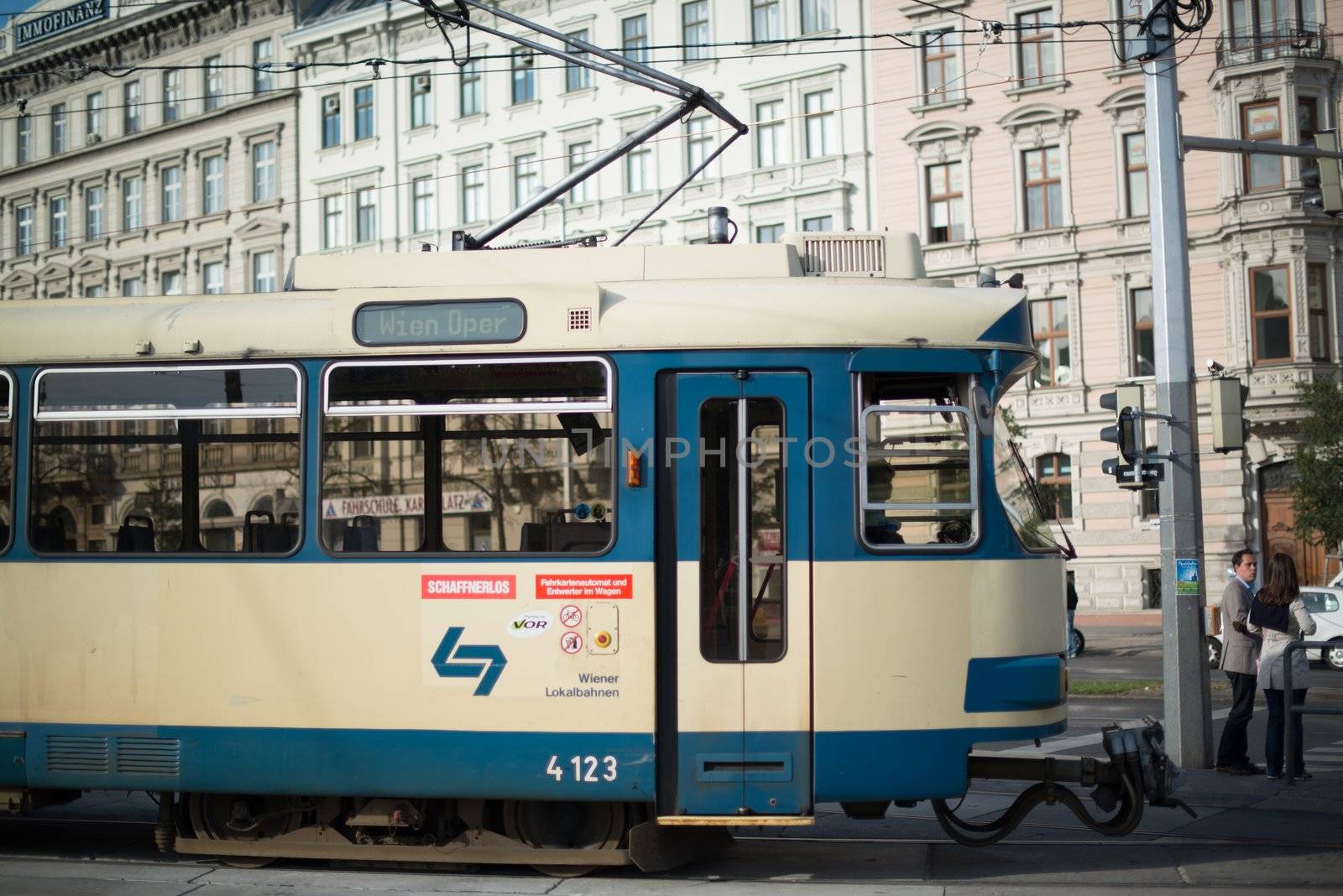 VIENNA - OCTOBER 5: An old blue tram is driving through the town heading to the Vienna Opera on October 5, 2012 in Vienna, Austria. Trams are an important means of travel besides the metro still.
