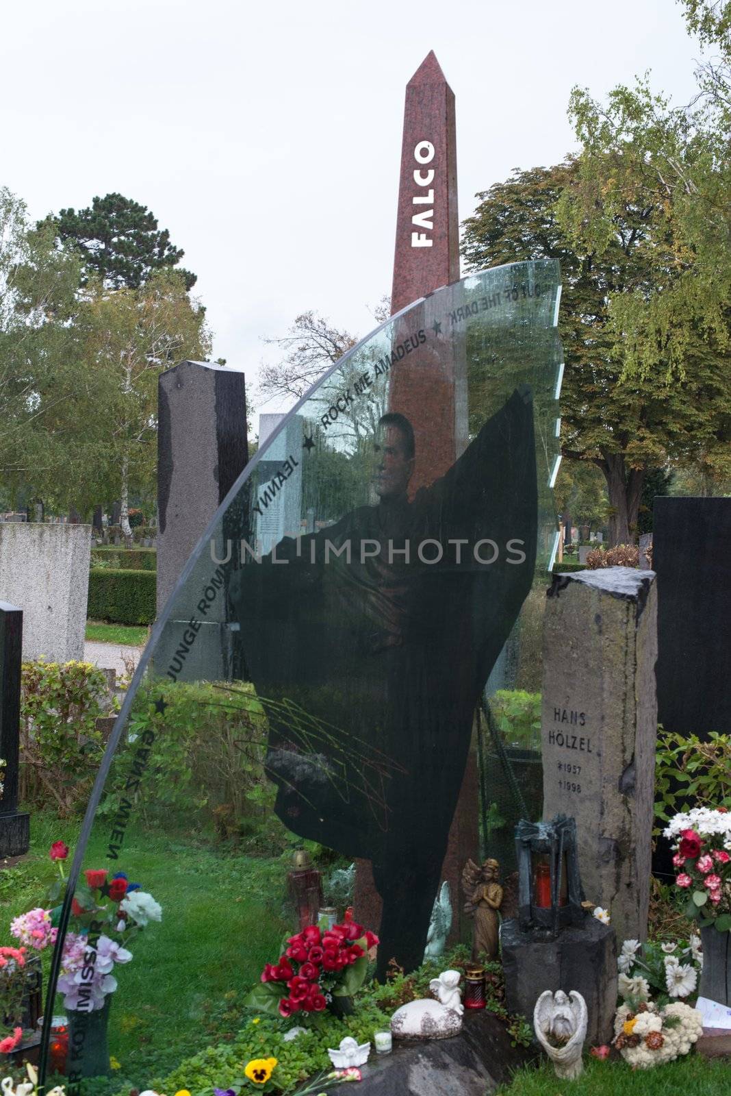 VIENNA - OCTOBER 7: Memorial at Falco’s grave in Zentralfriedhof (Central Cemetery) on October 7, 2012 in Vienna, Austria. Falco was an Austrian pop singer, rapper and musician. His hit single “Rock me Amadeus” was the first and so far only song in German language that ever hit the US Billboard charts. Falco died 1998 in the Dominican Republic and was buried in his home town Vienna, where still many fans pay their respect by visiting his grave every day.