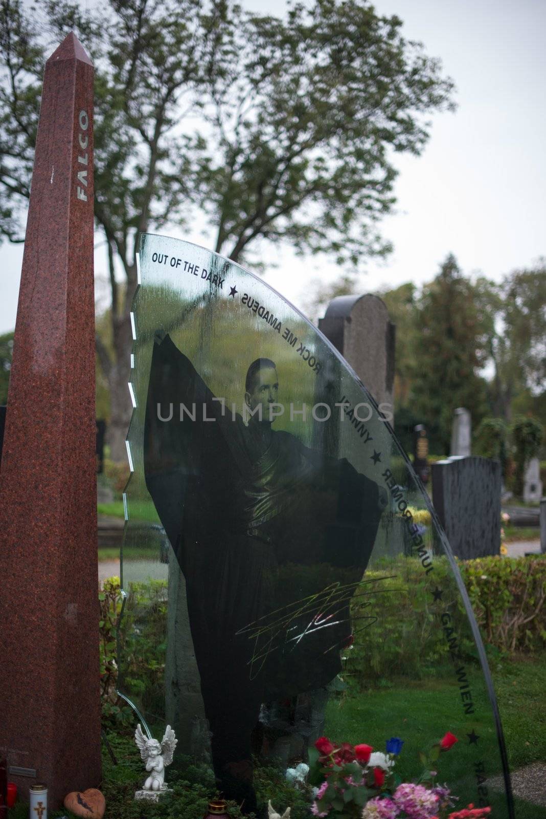 VIENNA - OCTOBER 7: Memorial at Falco’s grave in Zentralfriedhof (Central Cemetery) on October 7, 2012 in Vienna, Austria. Falco was an Austrian pop singer, rapper and musician. His hit single “Rock me Amadeus” was the first and so far only song in German language that ever hit the US Billboard charts. Falco died 1998 in the Dominican Republic and was buried in his home town Vienna, where still many fans pay their respect by visiting his grave every day.
