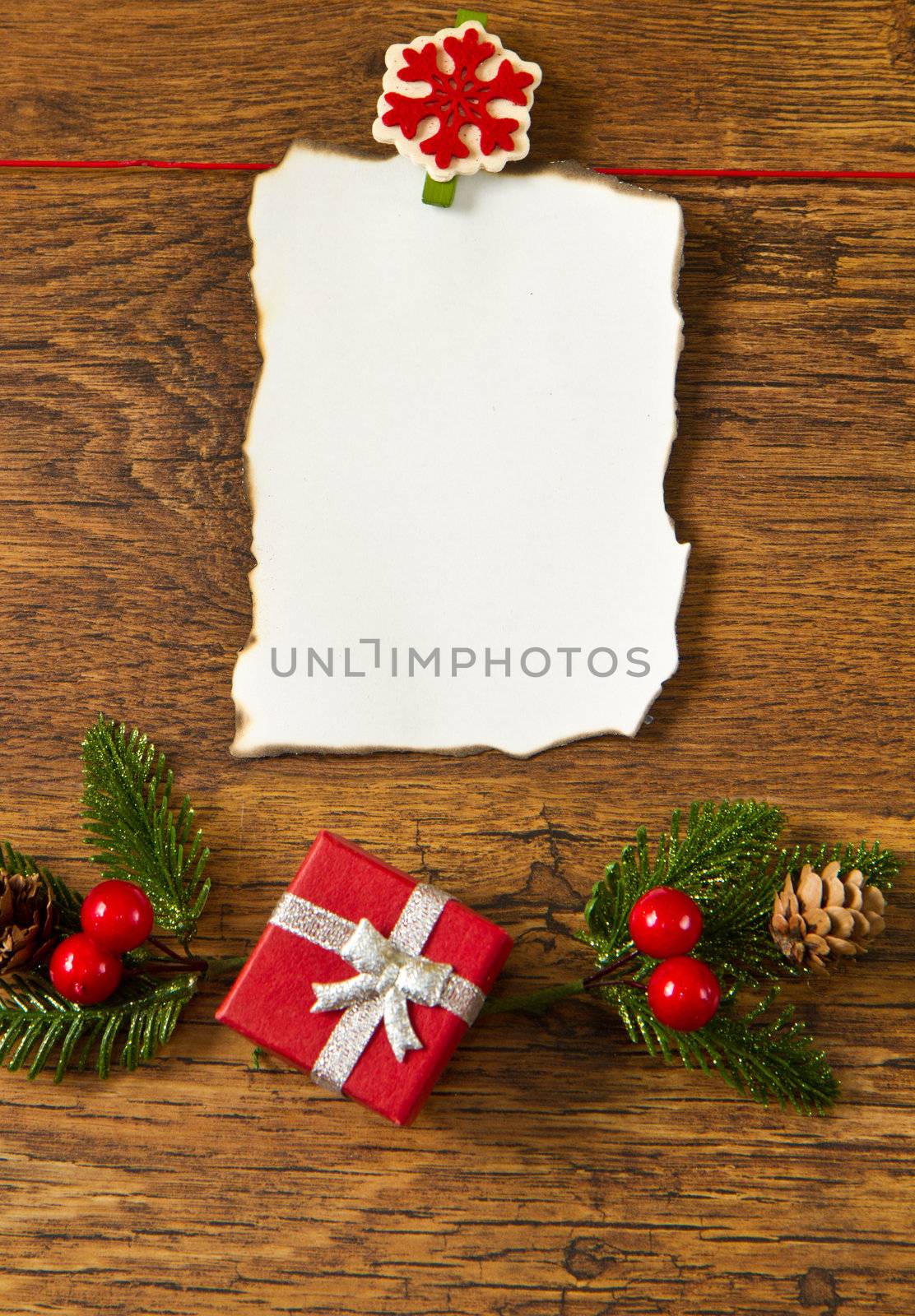 blank note with christmas decoration on wooden background  by lsantilli