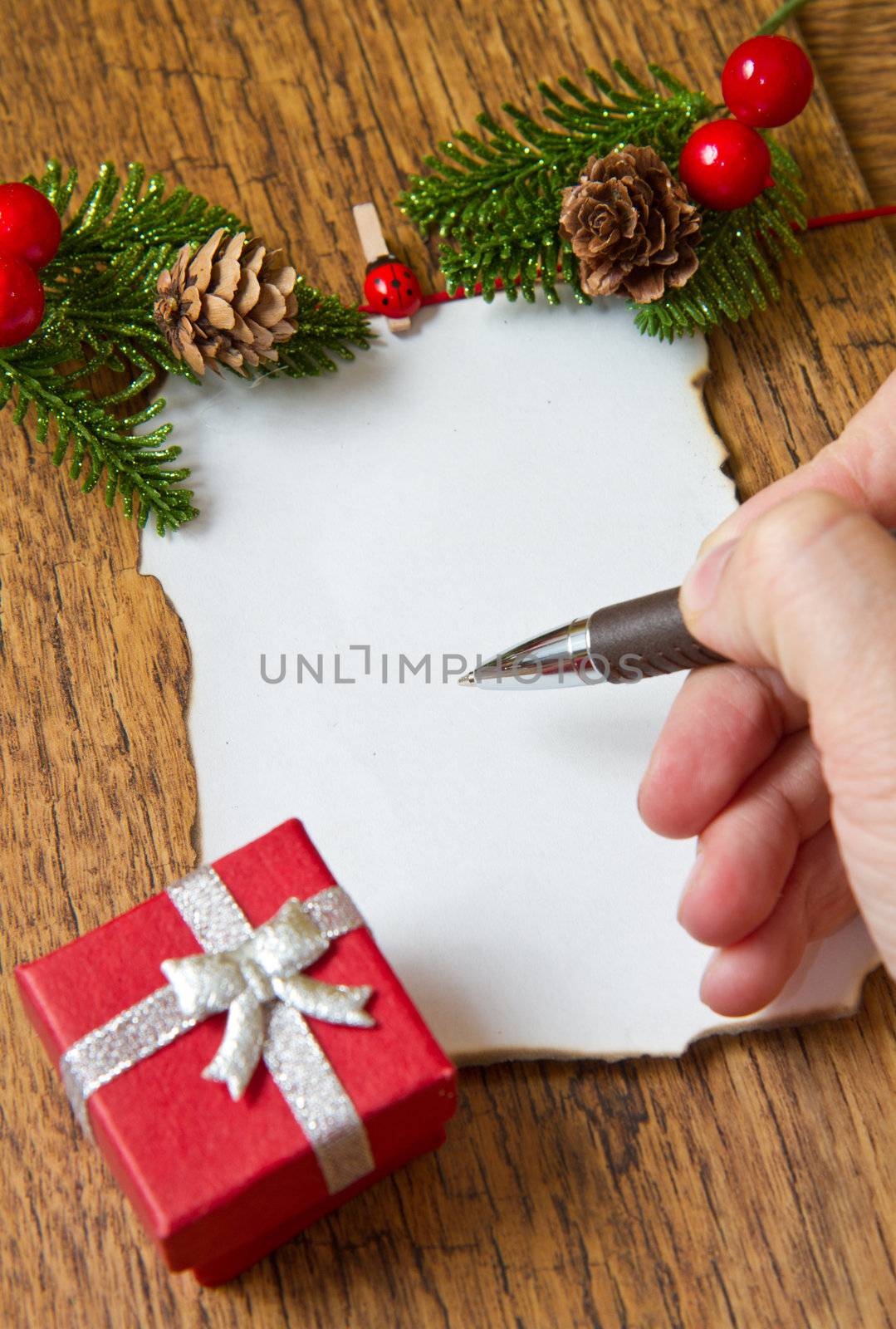 blank note with christmas decoration on wooden background  by lsantilli