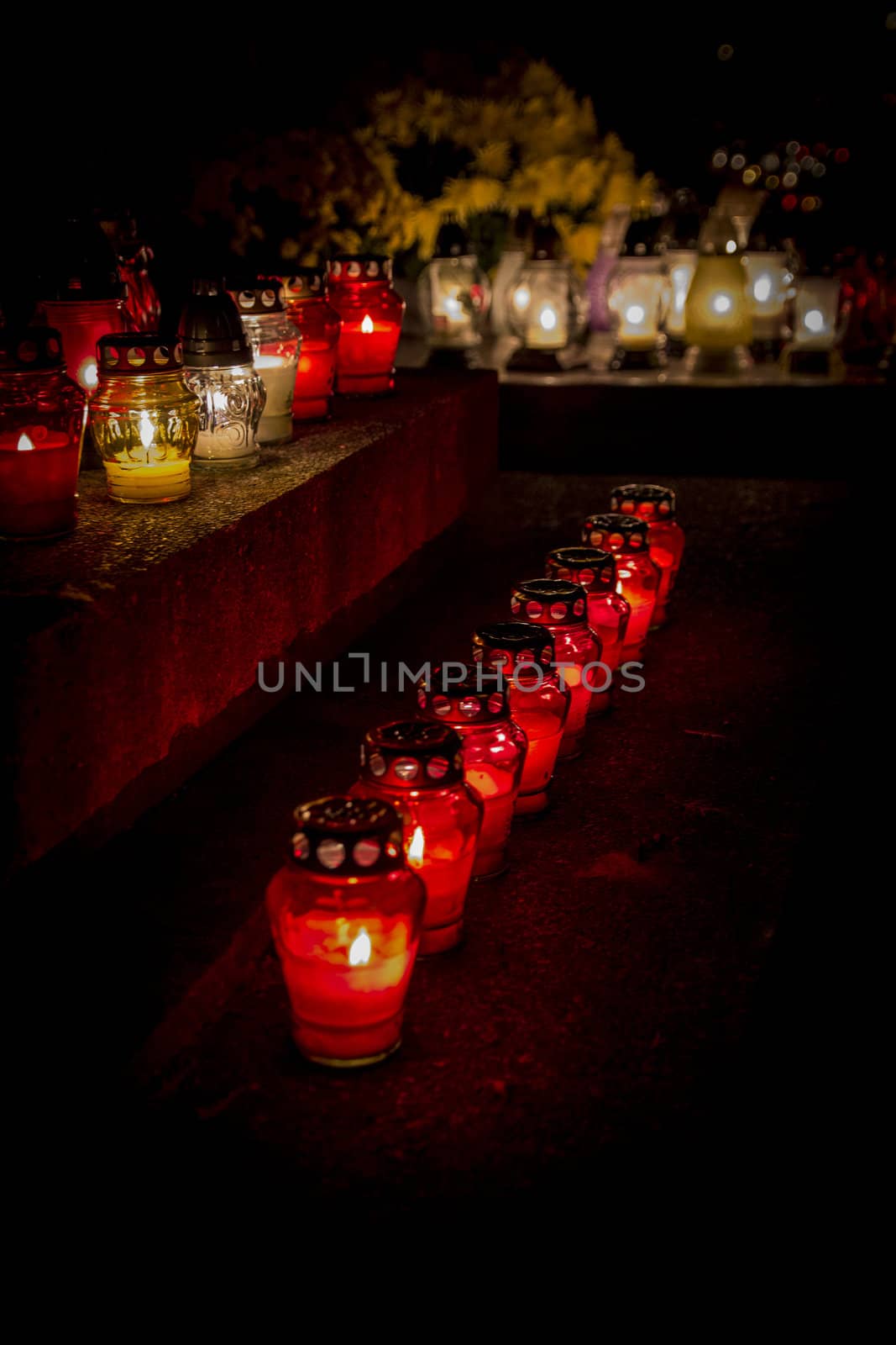 All Saints' Day at a cemetery in Poland - flowers and light candles to honor the memory of deceased relatives.