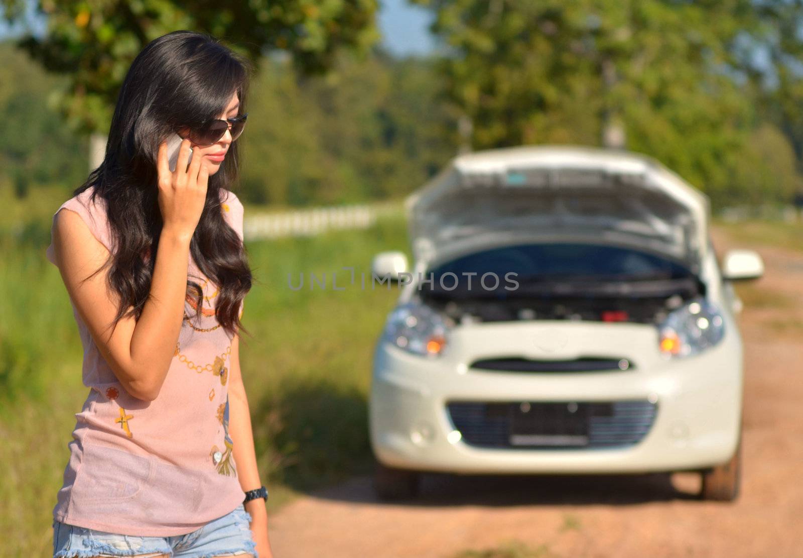 A woman calls for assistance  after her car broke down 