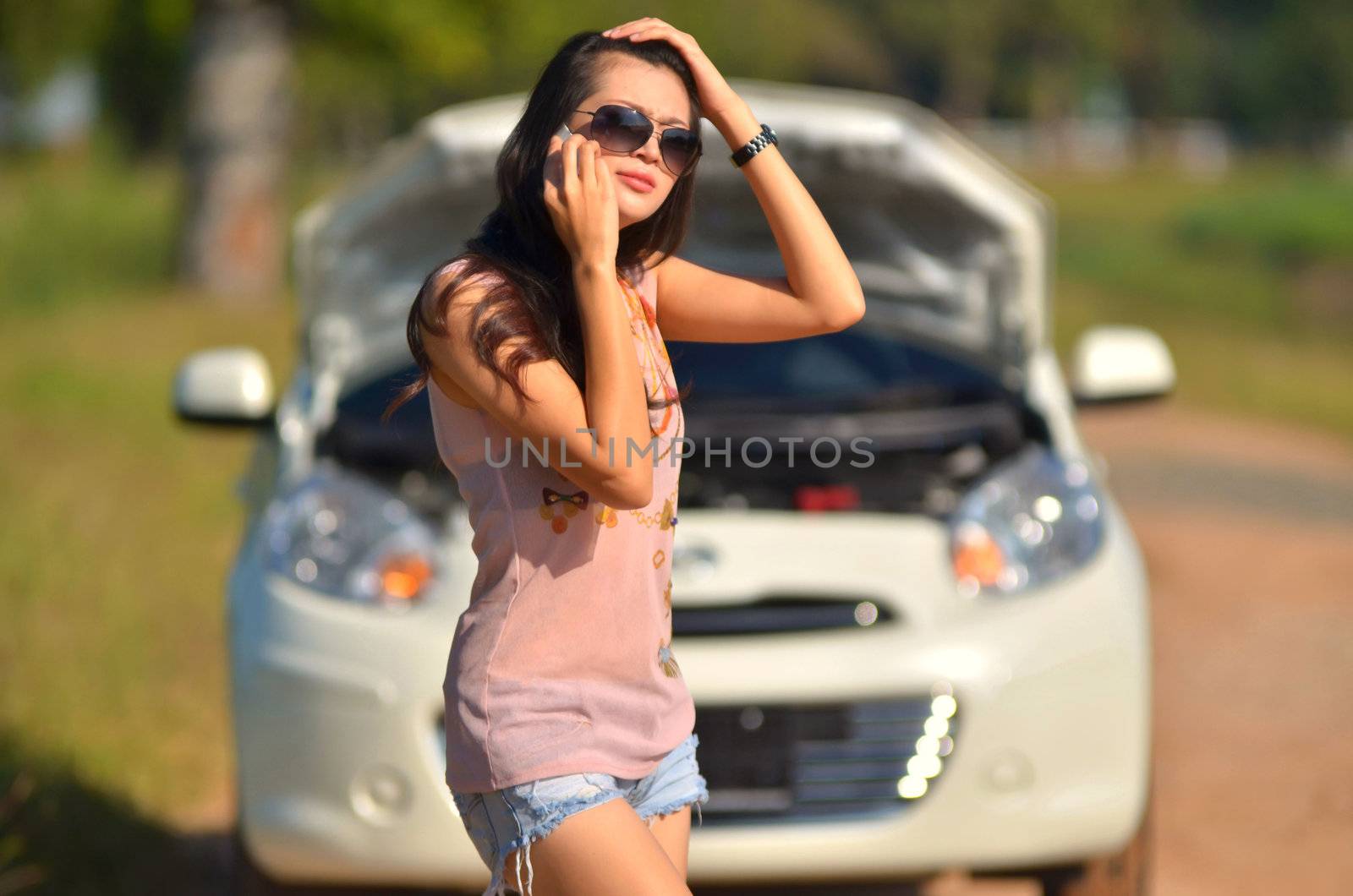 A woman calls for assistance  after her car broke down 