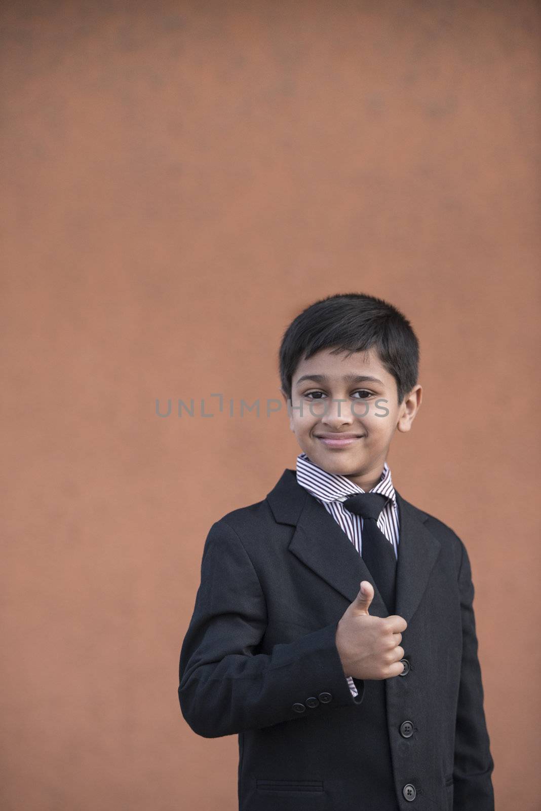 Portrait of a Handsome Little Boy in a Business Suit