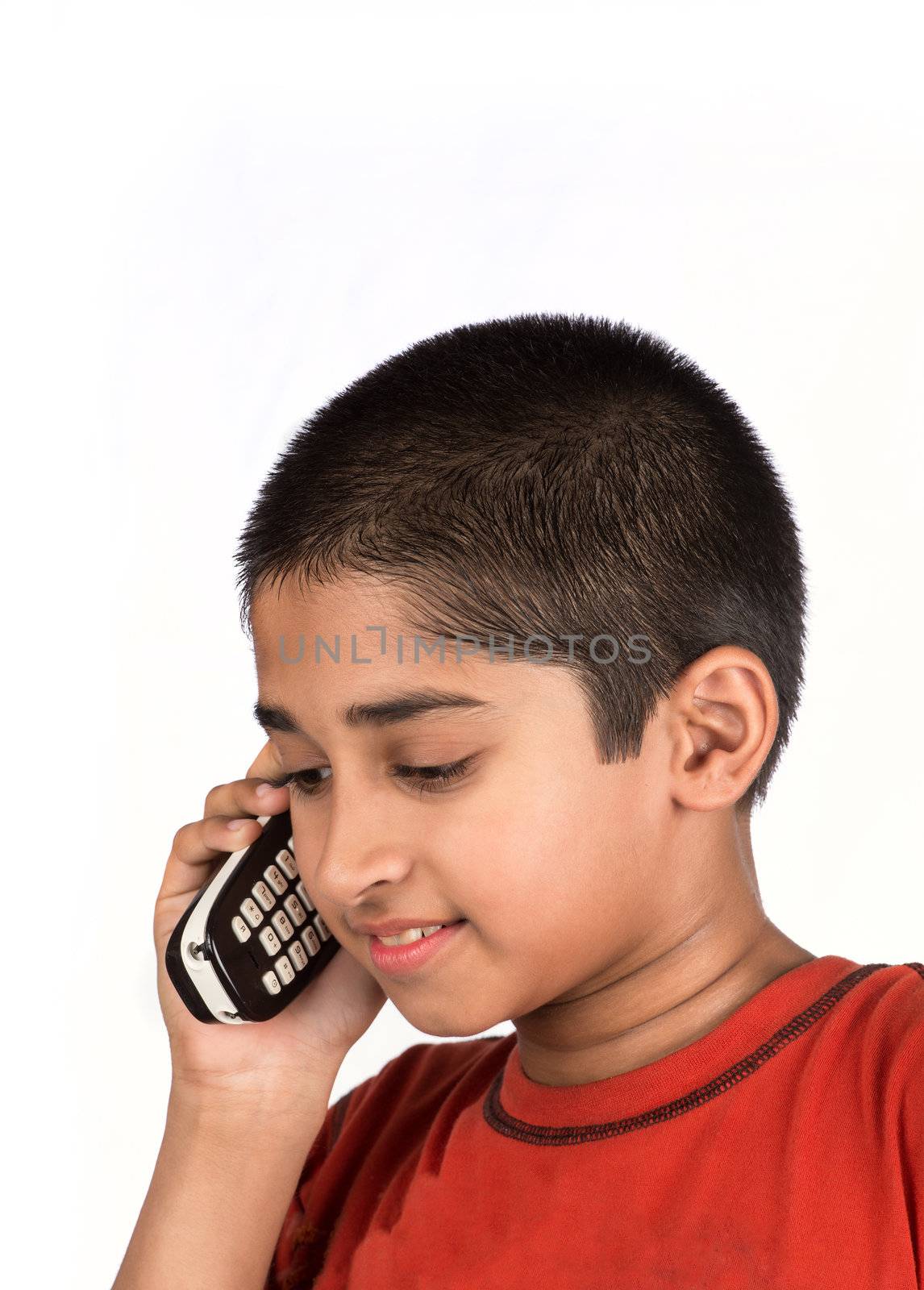 Portrait of a handsome young boy with a telephone 