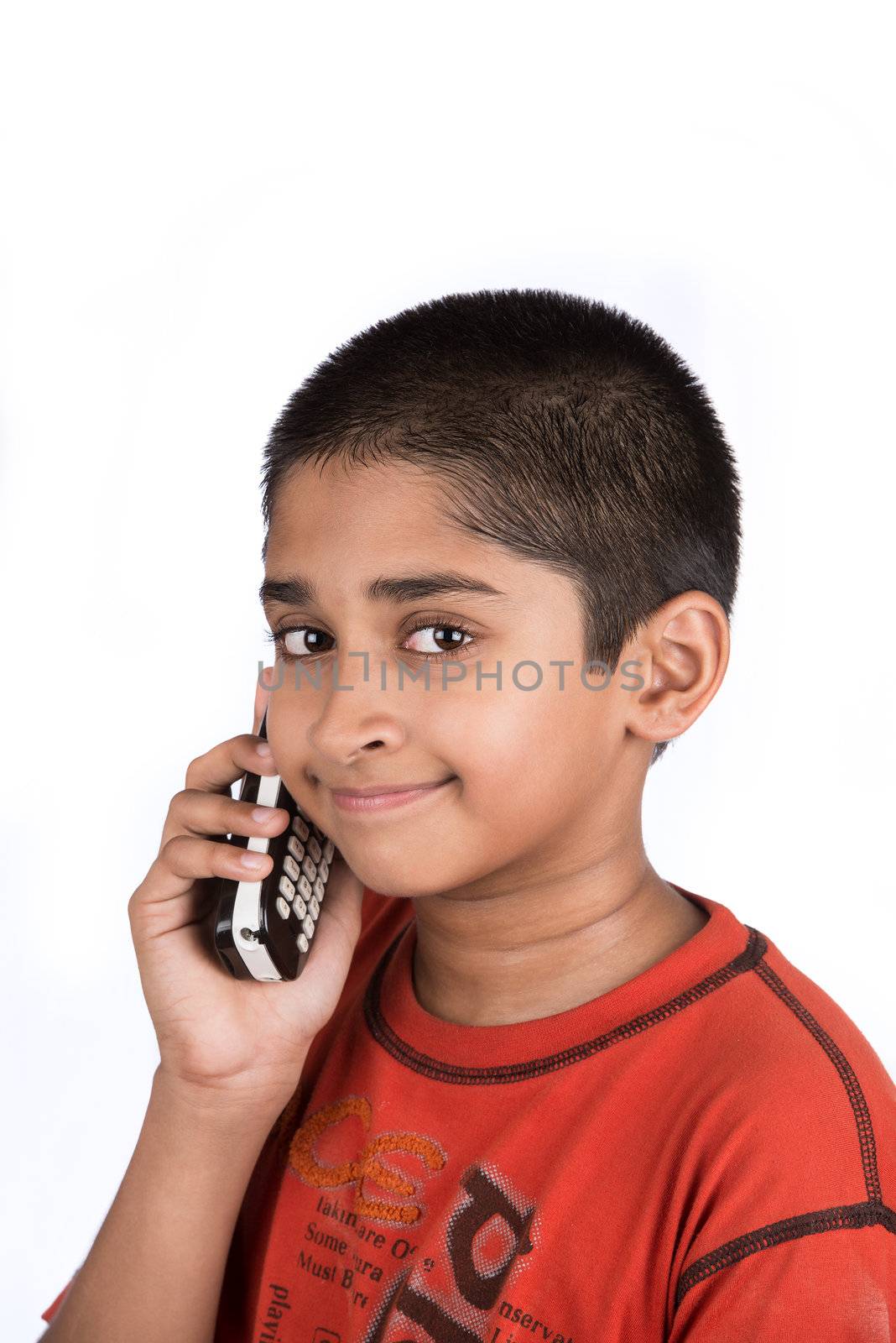 Handsome Indian kid looking very happy talking on phone