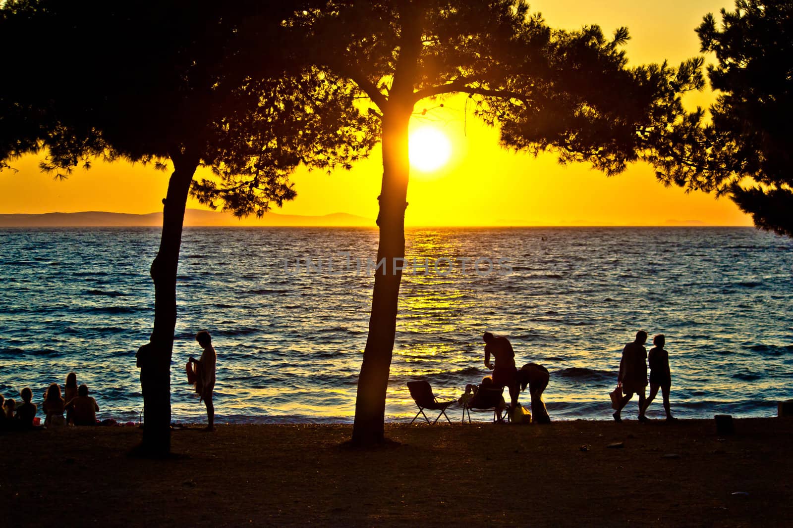 People silhouette on beach at sunset by xbrchx