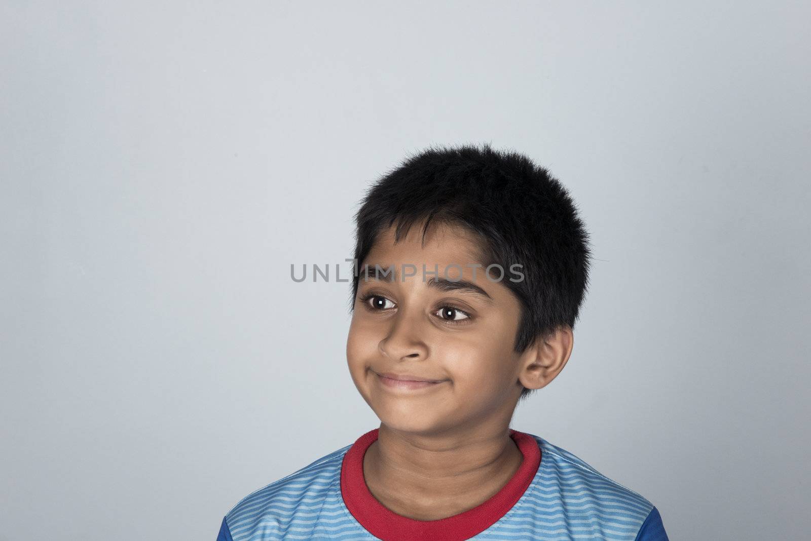 Handsome Indian toddler standing outdoor smiling