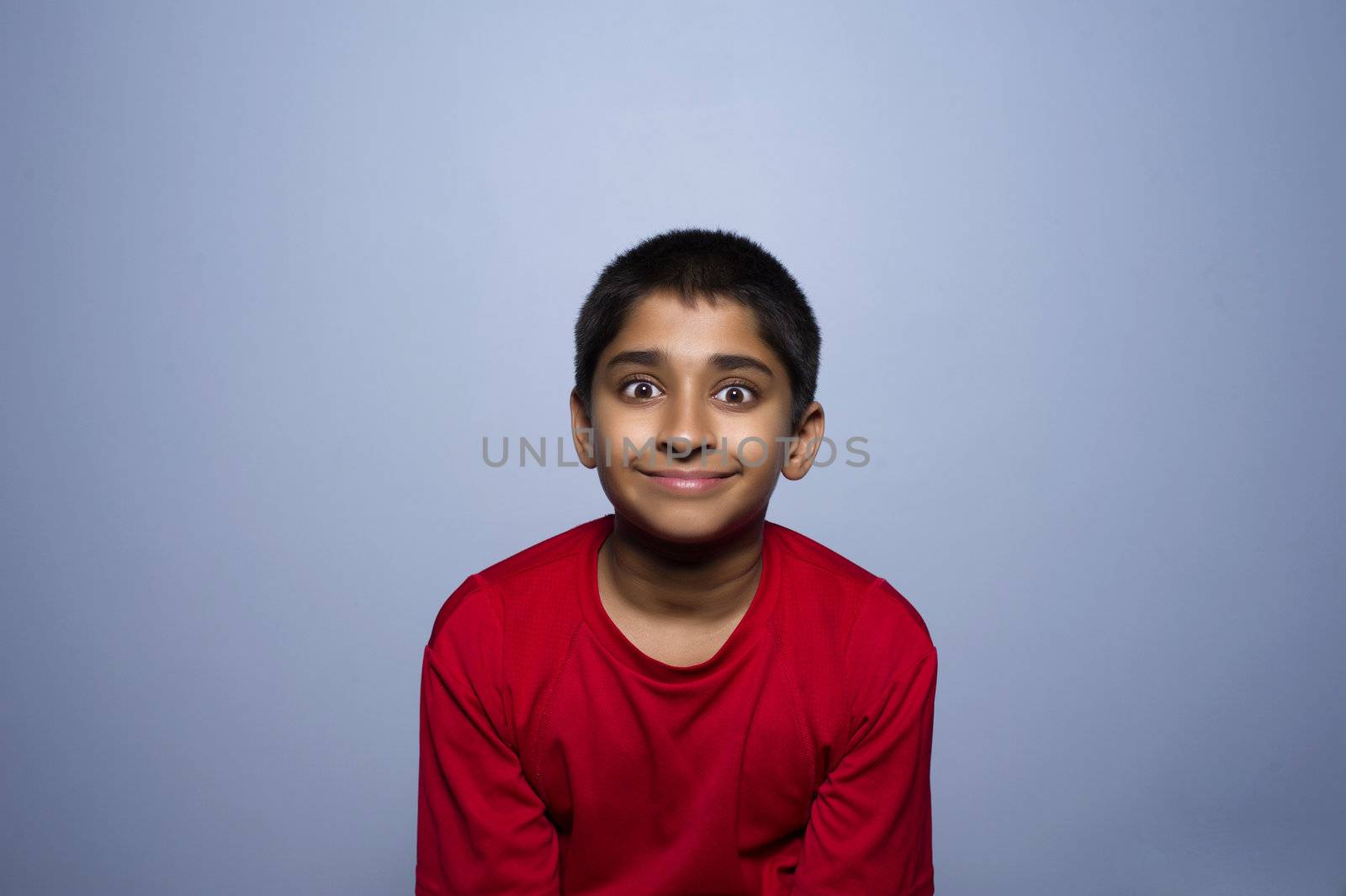 An handsome indian kid lookibg very excited