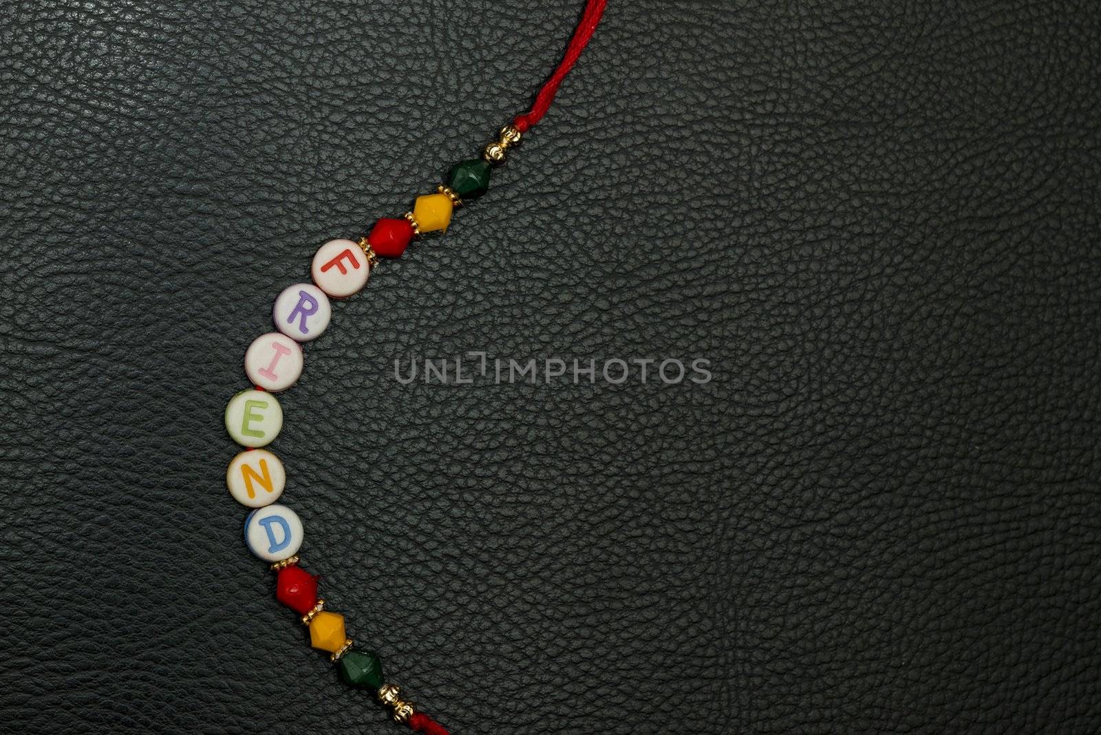 A friendship band isolated on a leather background