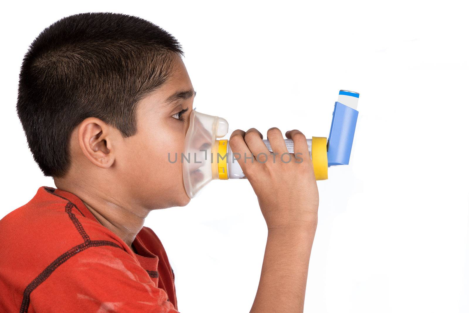 Close up image of a cute little boy using inhaler for asthma. White background 