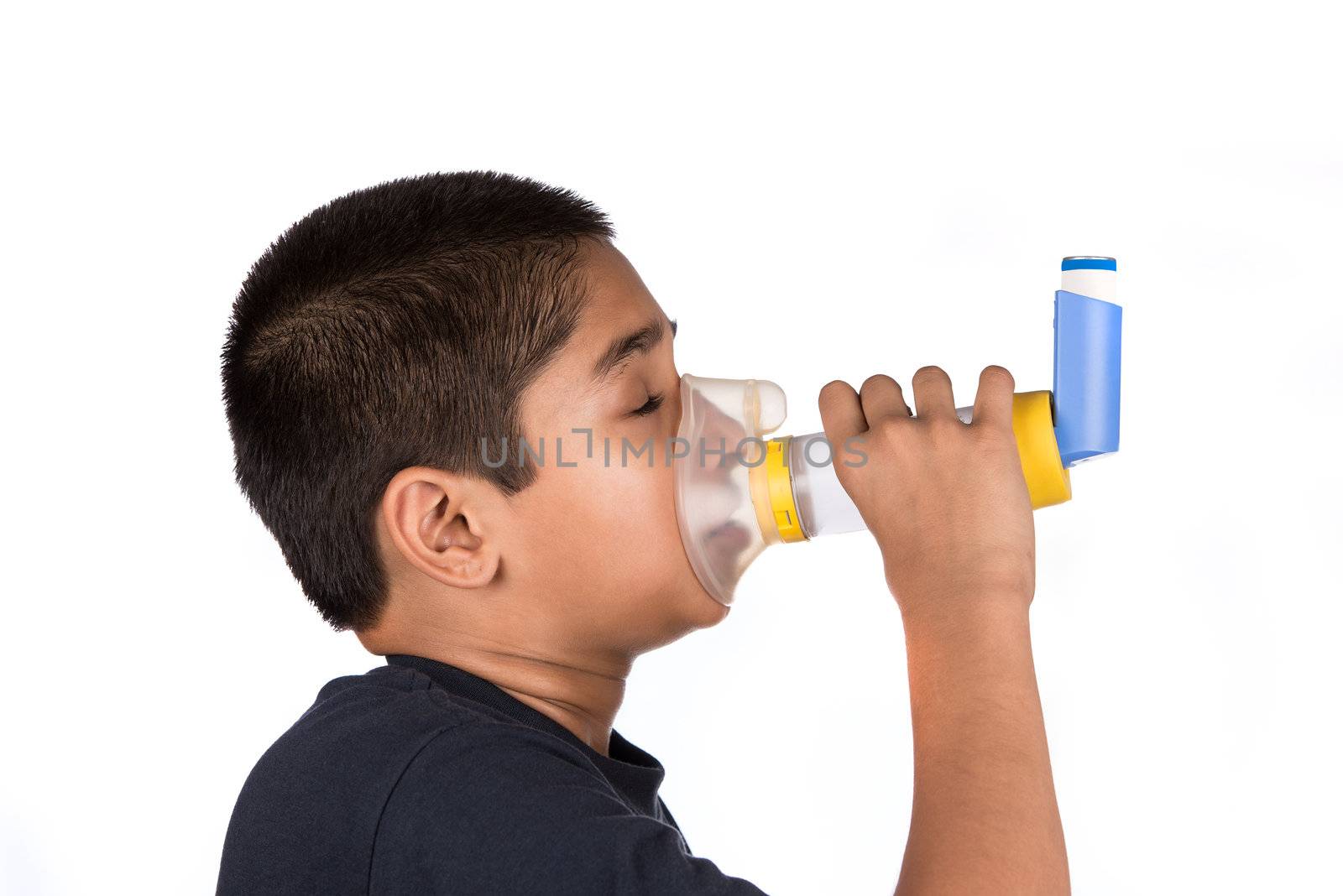 Close up image of a cute little boy using inhaler for asthma. White background 