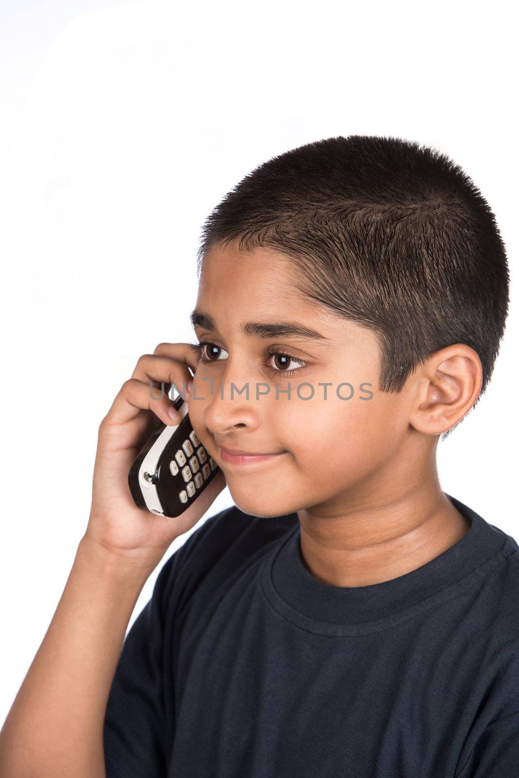 Handsome Indian kid looking very happy talking on phone