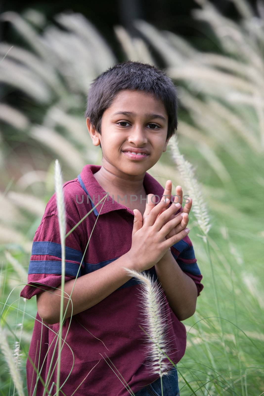 Handsome Indian toddler standing outdoor smiling