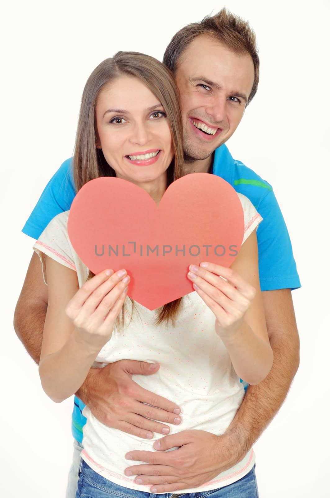 Couple in love smiling holding a red heart by mmajk
