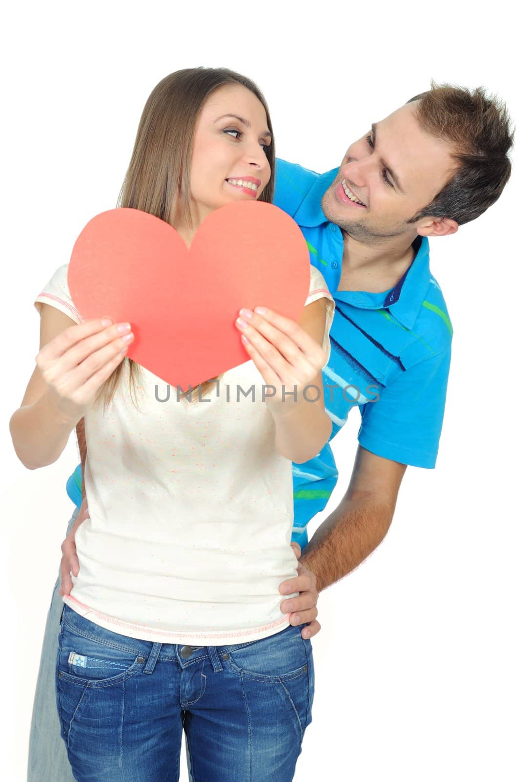 Couple in love smiling holding a red heart by mmajk