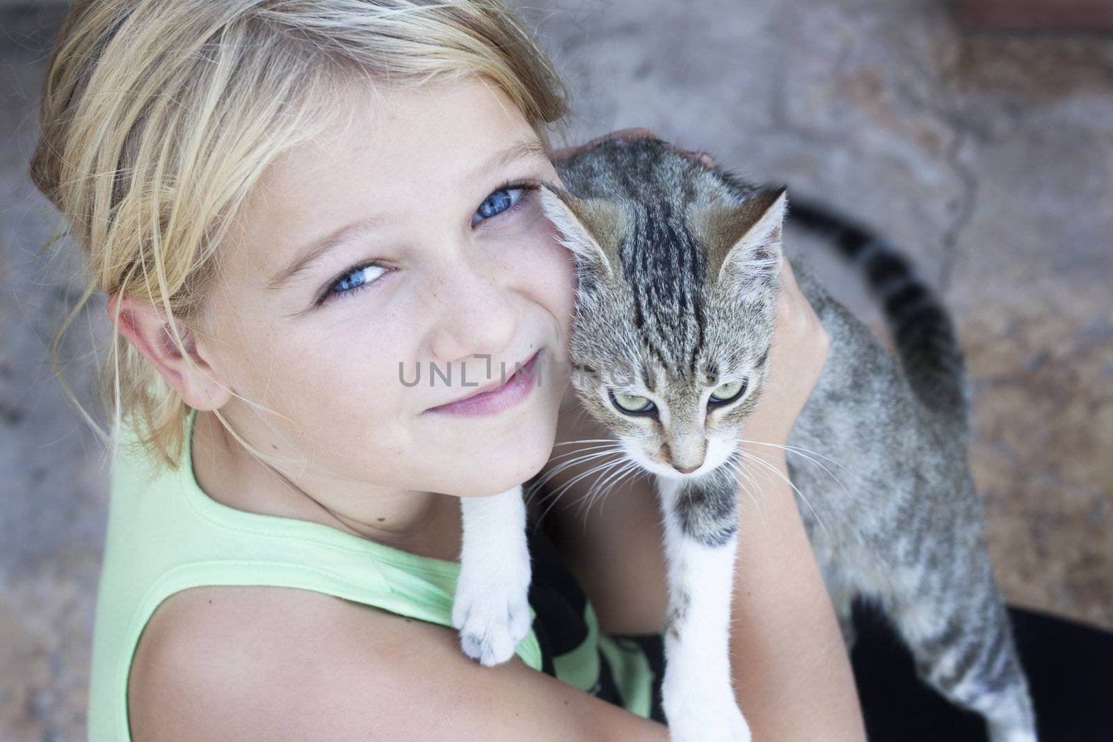 A pretty girl holding an angry looking cat