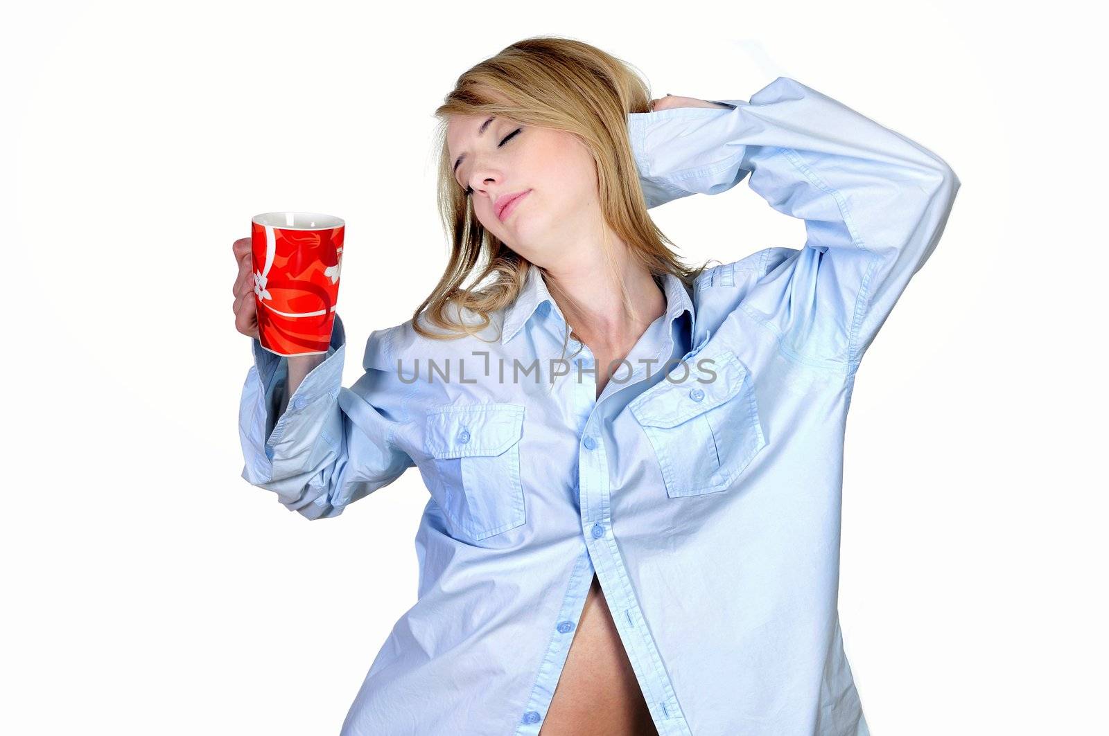 Stretching young woman wearing her boyfriend's shirt