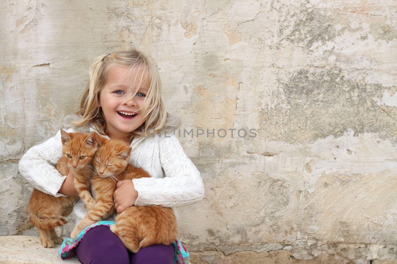 Cute girl holding kittens by annems