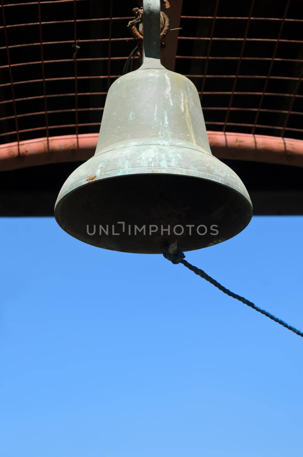 Vintage school bell shot against blue sky