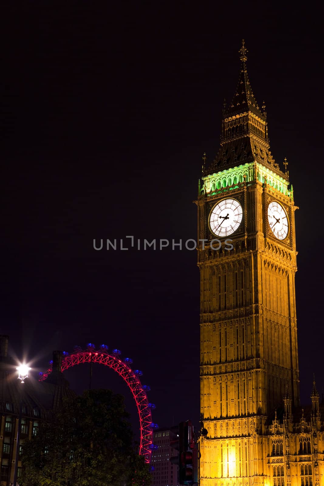 Big Ben (Houses of Parliament) in London.  The London Eye is in the background.