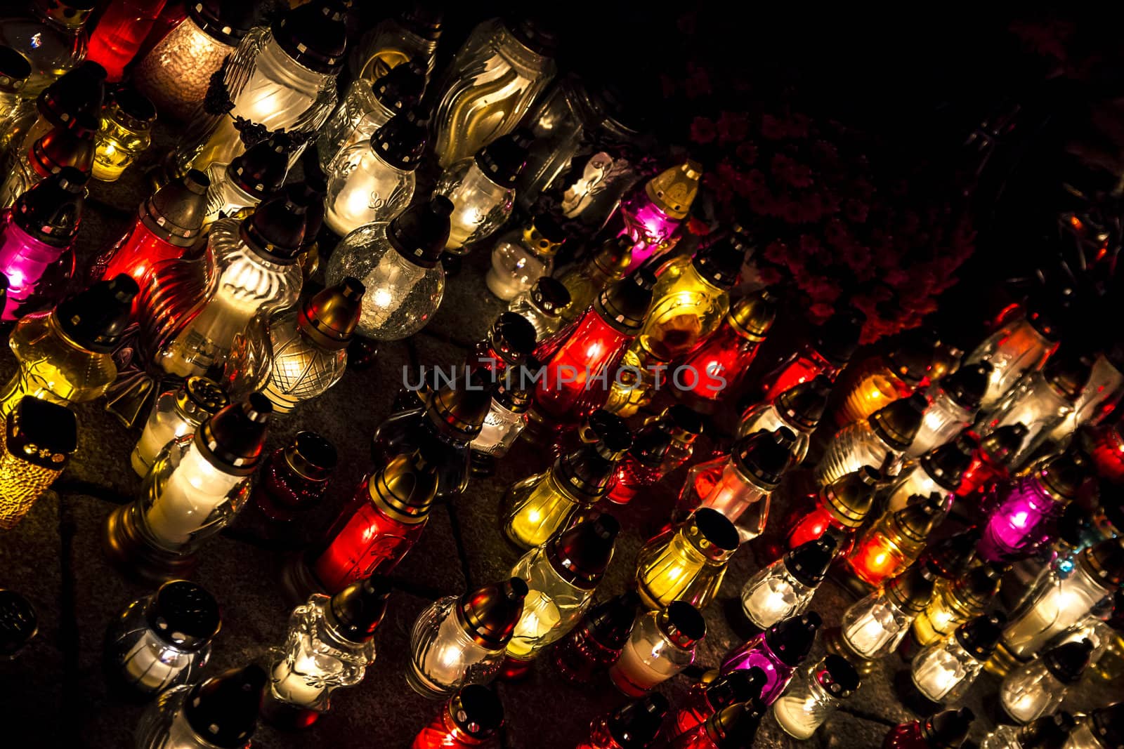 All Saints' Day at a cemetery in Poland - flowers and light candles to honor the memory of deceased relatives.