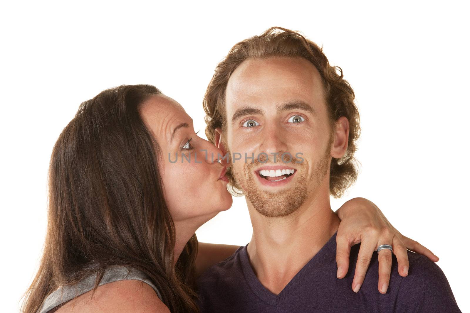 Excited young man embraced and kissed by woman