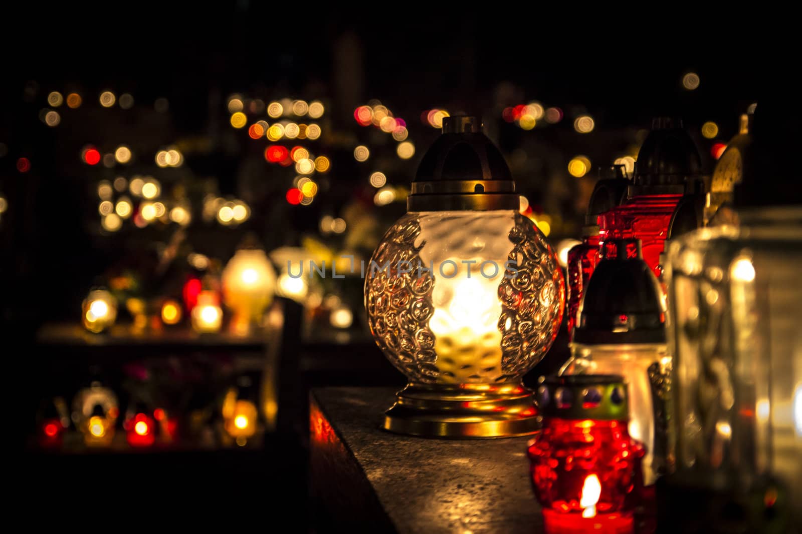 All Saints' Day at a cemetery in Poland - flowers and light candles to honor the memory of deceased relatives.