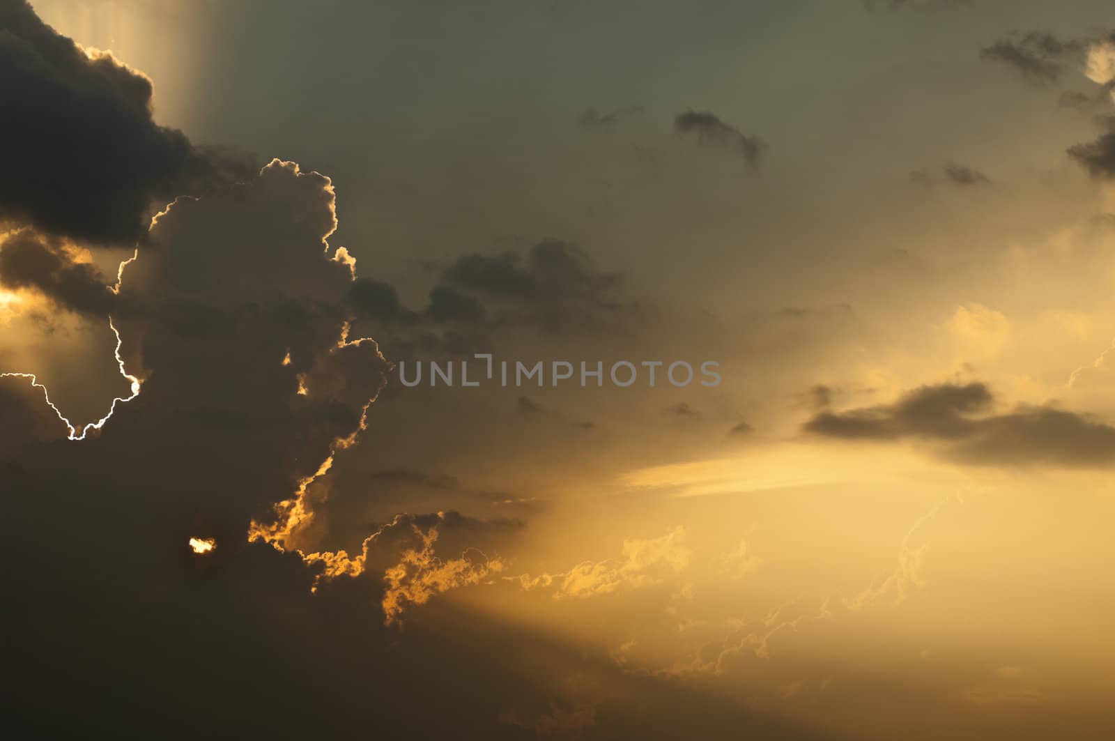 Dramatic sunburst through cumulus clouds in the evening