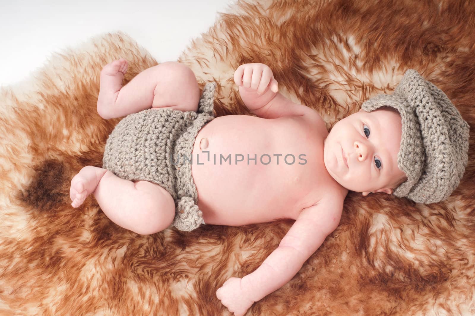 Shot of newborn baby lying on fur