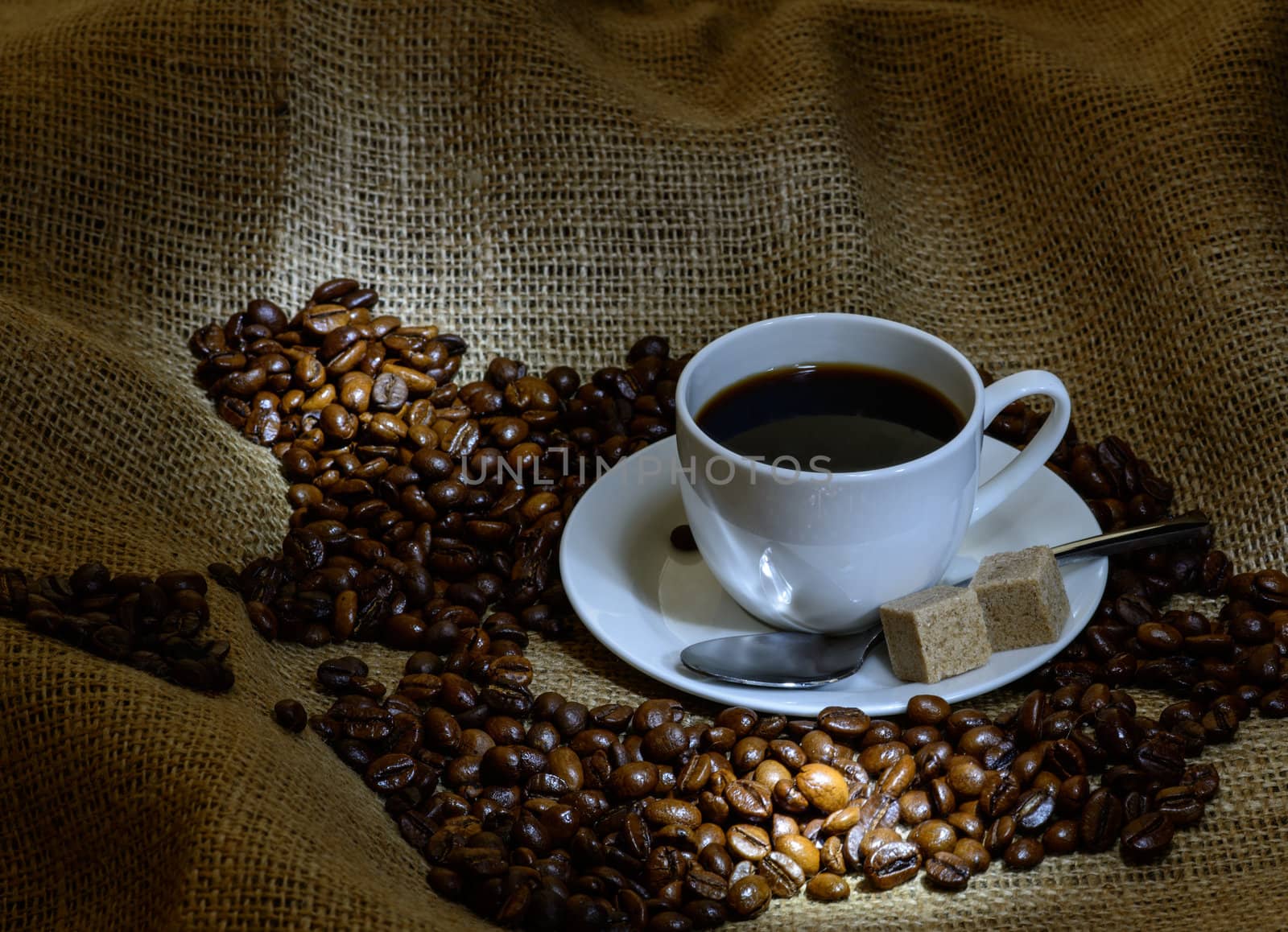 Coffee cup, beans and burlap. still life