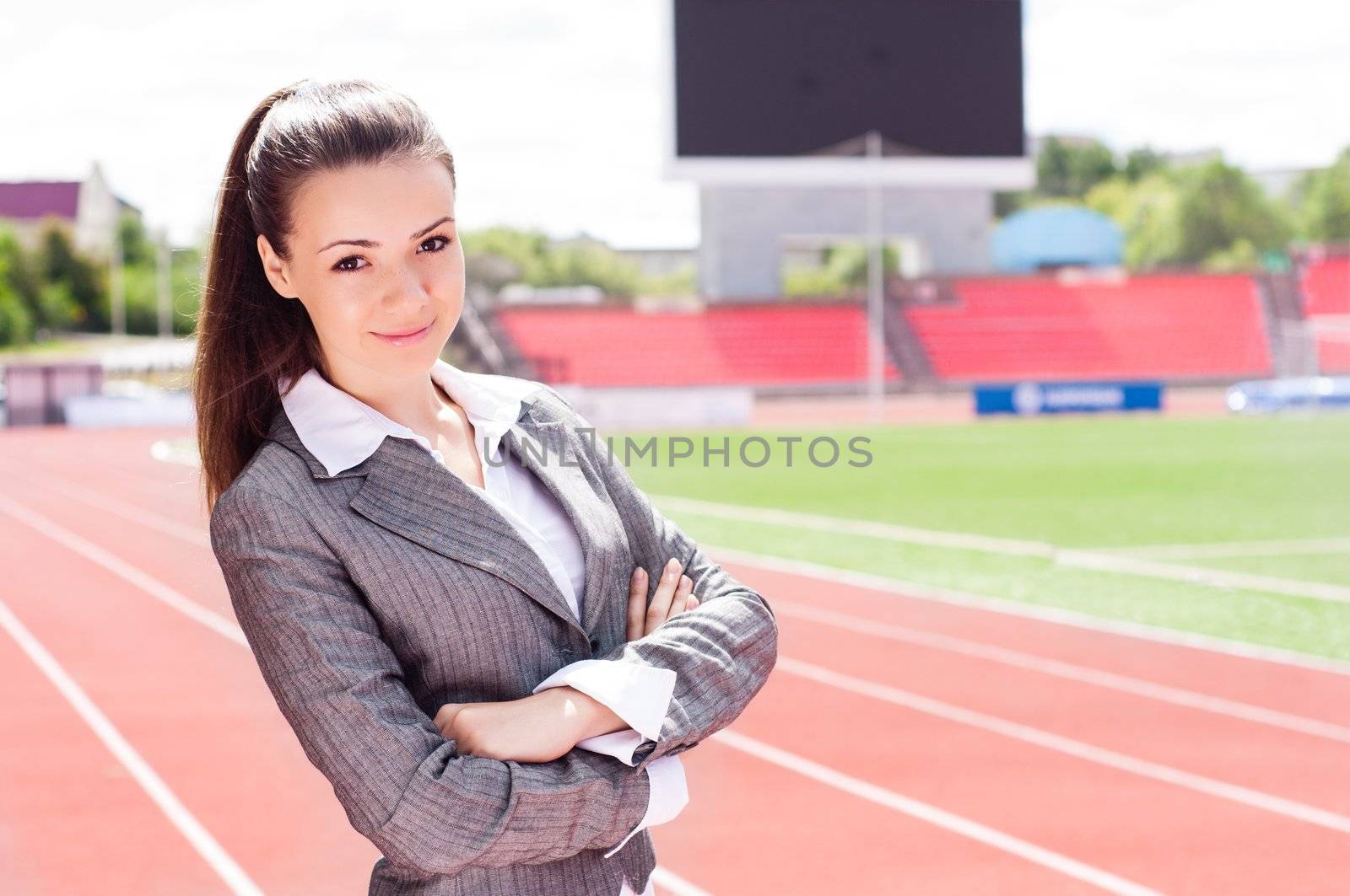 portrait of a beautiful business woman at a sports stadium, the competition in the business