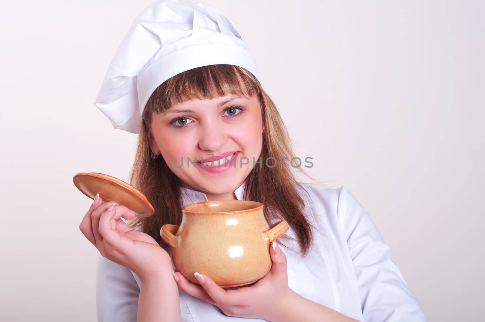 attractive woman keeps a pot of food, white background