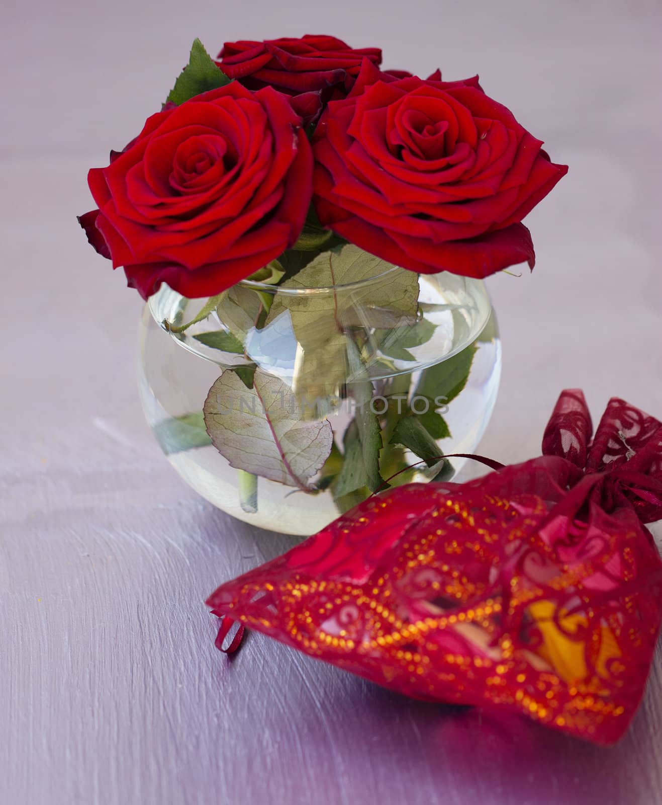 vase with red roses on the table by victosha