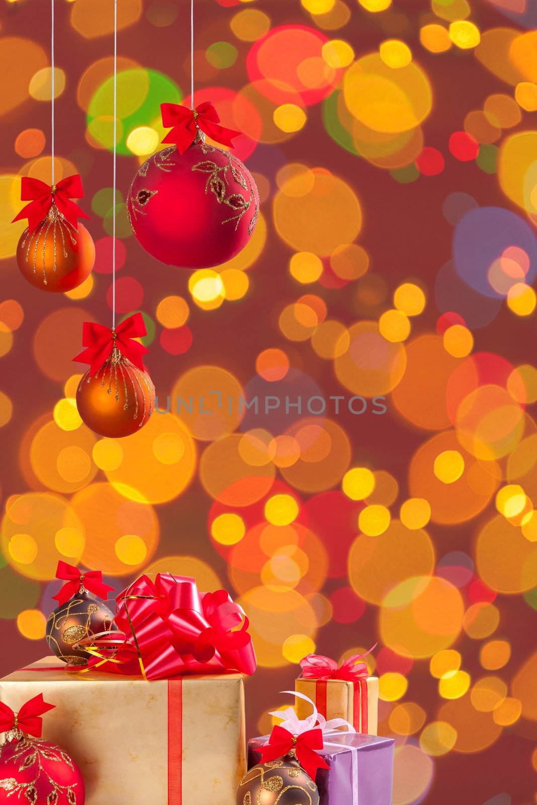 Gifts and cristmas balls on ribbon on festive background