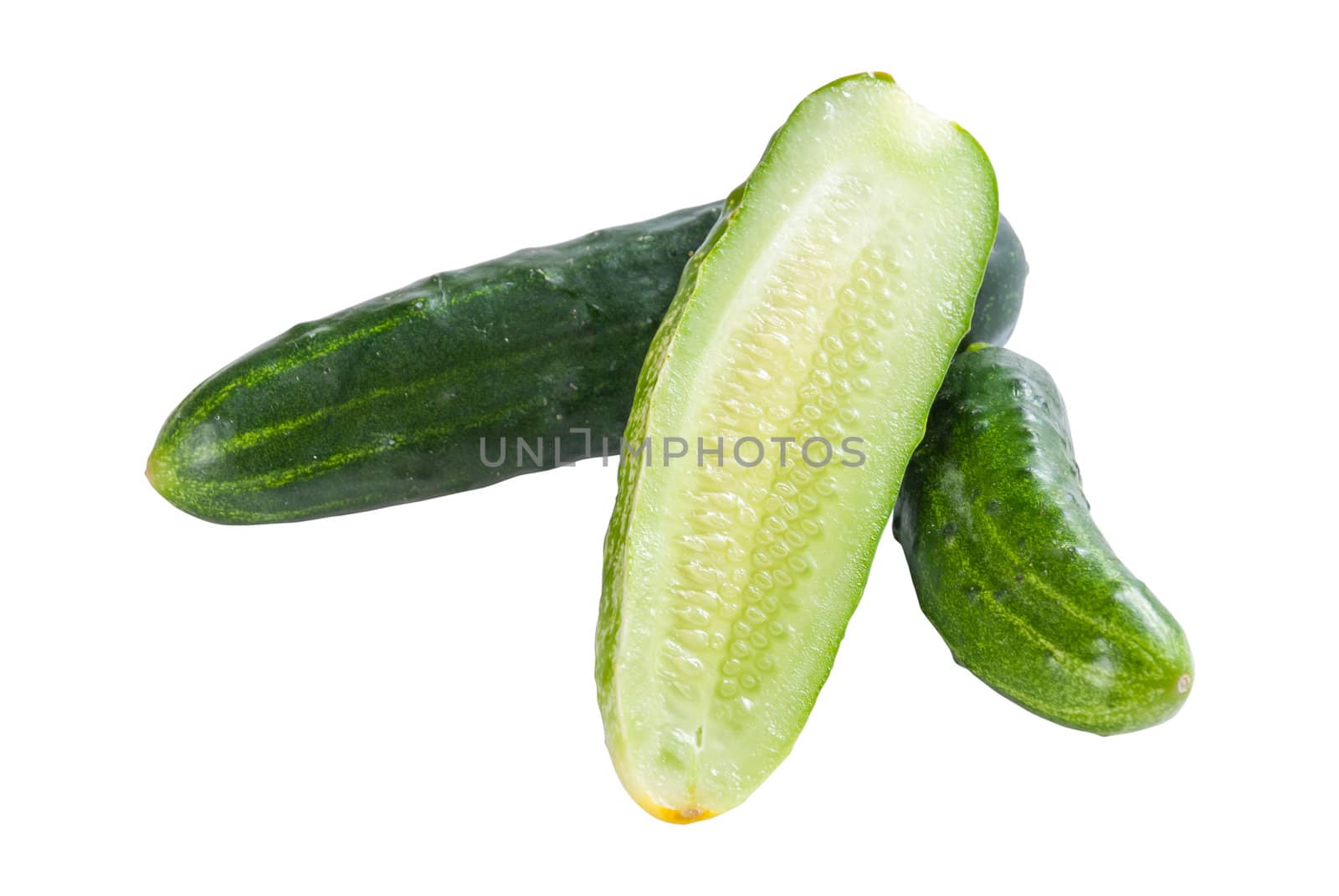 Green whole and sliced cucumbers vegetables isolated on white background. Studio photo