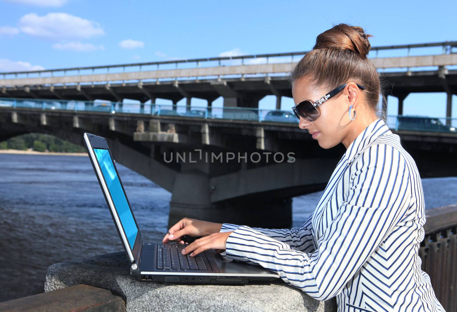 businesswoman with laptop on quay by ssuaphoto