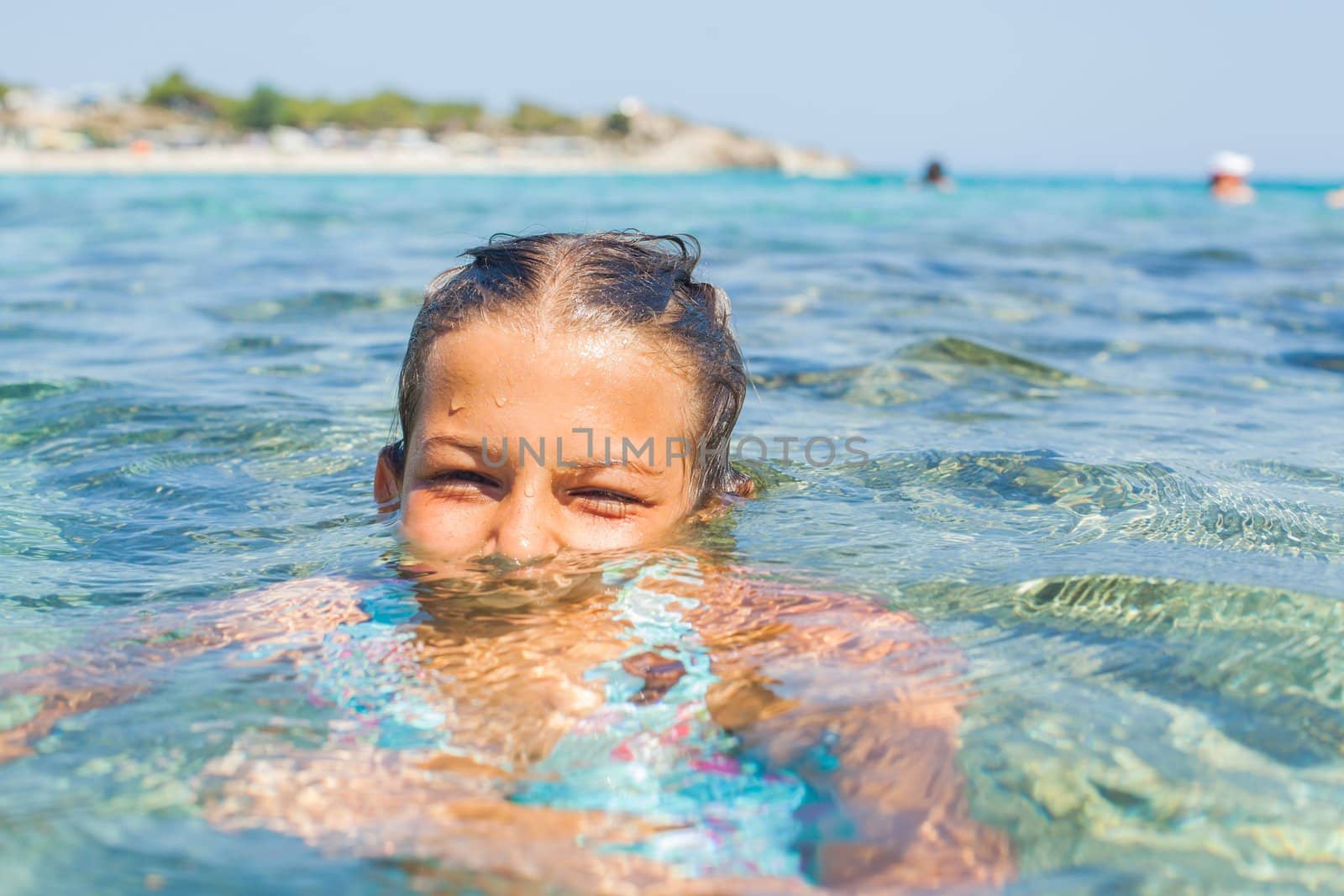 Young girl playing in the sea by maxoliki