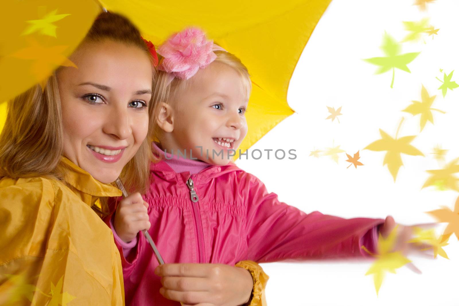 Mother and daughter under umbrella catching falling leaves, over white