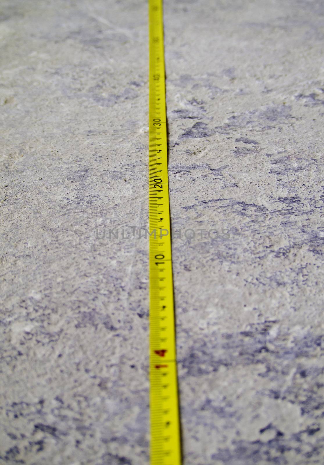 Construction Measuring Tape on concrete floor by siraanamwong